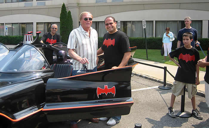 Adam West sits in the "Rock Star" Batmobile.